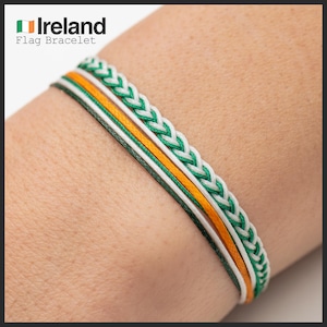 May include: A green, white, and orange braided bracelet with the text "Ireland Flag Bracelet".