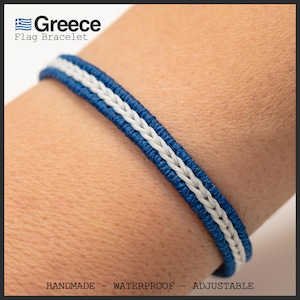 May include: A blue and white braided bracelet with the text "Greece Flag Bracelet". The bracelet has a blue border with a white braided center. The text "HANDMADE - WATERPROOF - ADJUSTABLE" is at the bottom.