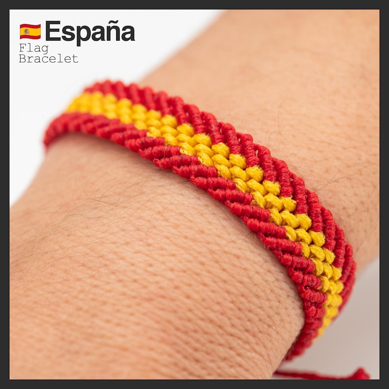 May include: A woven bracelet featuring the colors of the Spanish flag: red and yellow. The bracelet is worn on a wrist. The text "Espa&ntilde;a" and "Flag Bracelet" are visible in the upper left corner.