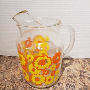 Vintage large glass pitcher with bright flowers