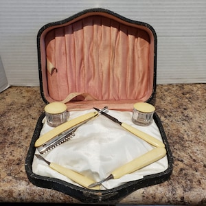 ヴィンテージの木製の蓋付き小物入れ。金と黒の幾何学模様。赤い