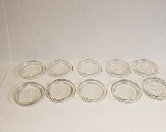 Group of 10 glass sealer lids. 2 have damage