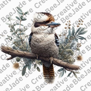 May include: A brown and white kookaburra bird perched on a branch with green and grey foliage. The bird has a blue and black patterned chest and a long, striped tail.