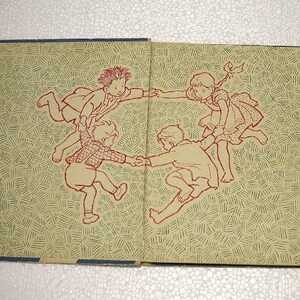 May include: An illustration of four children holding hands and forming a circle. The children are drawn in a simple style with red outlines and are on a background of green and red lines.