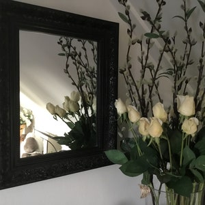 Old wooden mirror with wide black decorated edge - wood treated with white plaster to create beautiful relief - elongated model
