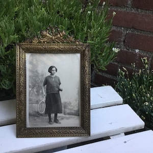 Photo frame with beautifully decorated edge and a crown of a torch and arrow quiver - Antique French Photo Frame made around 1900