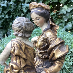 Statue of Mother Mary with baby Jesus in beautiful gold robe and beautifully depicted faces - 17th century style - beautiful decoration