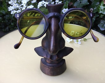 Old glasses with strong yellow/green lenses made around 1930 - Bronze-colored metal glasses stand made around 1990