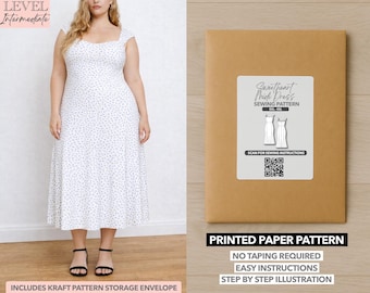 May include: A woman wearing a white midi dress with a blue floral pattern and black sandals. Next to her is a brown paper pattern envelope with a label that reads "Sweetheart Midi Dress Sewing Pattern." The text "Printed Paper Pattern" is also visible.