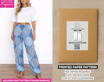 May include: A woman wearing blue patterned harem pants and a white crop top. A brown paper pattern envelope with the text "Harem Pants Sewing Pattern" is displayed. The text "Printed Paper Pattern" and "Includes Kraft Pattern Storage Envelope" are also visible.