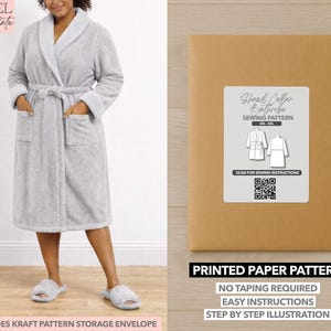 May include: A light gray, long-sleeved bathrobe with a shawl collar, pockets, and a matching belt. The image also shows a kraft paper envelope with a label that reads "Shawl Collar Bathrobe Sewing Pattern". The text "Printed Paper Pattern" is also visible.