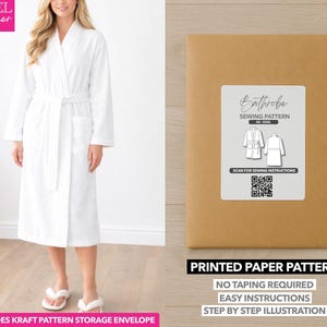 May include: A white bathrobe with a matching belt and pockets. The image also shows a sewing pattern for a bathrobe, with text that reads "Bathrobe Sewing Pattern" and "Printed Paper Pattern". The pattern includes a kraft paper storage envelope.