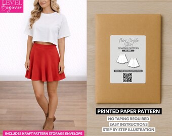 May include: A woman wearing a white crop top and a red mini skirt. A brown paper pattern envelope with a white label that reads "Mini Circle Skirt Sewing Pattern" is also in the image. The text "Printed Paper Pattern" is at the bottom.