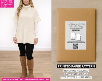 May include: A woman wearing a cream-colored turtleneck sweater dress with pockets, black leggings, and brown boots. A printed paper pattern for a turtleneck pocket sweater dress is displayed on the right. The pattern includes a kraft pattern storage envelope.