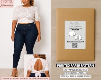 May include: A woman wearing a floral puff sleeve crop blouse and dark wash jeans. A brown paper pattern envelope with a white label that reads "Puff Sleeve Crop Blouse Sewing Pattern" is also shown. The text "Printed Paper Pattern" is below the label.