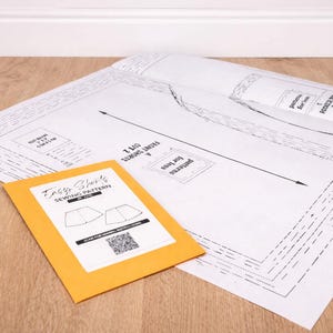 Easy Shorts Paper Sewing Pattern on a wooden workbench with manila envelop.