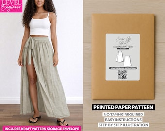 May include: A woman wearing a white crop top and a light green wrap skirt. A brown paper pattern envelope with a white label that says "Cover Up Skirt Sewing Pattern" is also shown. The envelope includes the text "Printed Paper Pattern".