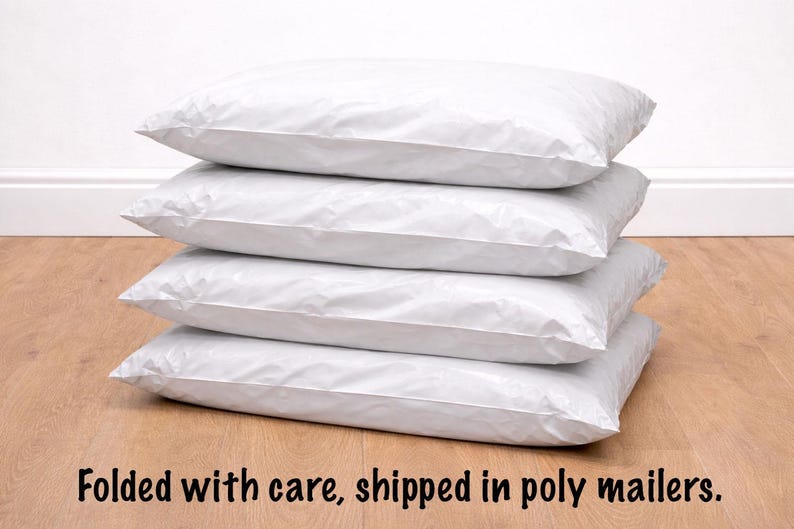 Stack of poly mailer bags with folded paper sewing pattern ready to ship.
