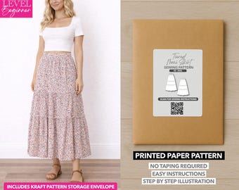 May include: A woman wearing a white crop top and a floral maxi skirt. Next to her is a brown paper pattern envelope with a label that reads "Tiered Maxi Skirt Sewing Pattern." The envelope also states "Printed Paper Pattern" and "No Taping Required."