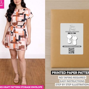 May include: A woman wearing a short-sleeved tunic dress with a geometric pattern in shades of pink, brown, and black. A kraft paper envelope with a "Tunic Dress Sewing Pattern" label is on the right. The pattern is for beginners.