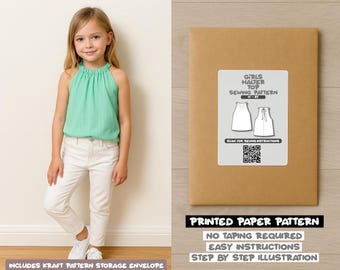 May include: A young girl wearing a mint green halter top and white pants. Next to her is a brown paper pattern envelope with a label that reads "GIRLS HALTER TOP SEWING PATTERN". The text "PRINTED PAPER PATTERN" is also visible.