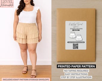 May include: A woman wearing a white top and tan ruffled shorts. Next to her is a brown paper pattern envelope with a label that reads "Ruffled Tiered Skirt Sewing Pattern". The envelope also states "Printed Paper Pattern" with easy instructions.
