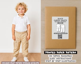 May include: A young boy wearing a white polo shirt and khaki cargo pants stands next to a brown paper pattern envelope. The envelope has a label that reads "Boys Cargo Pants Sewing Pattern". The text "Printed Paper Pattern" is also visible.