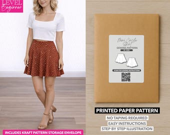 May include: A woman wearing a white crop top and a brown polka-dot skirt. Next to her is a brown paper pattern envelope labeled "Mini Circle Skirt Sewing Pattern." The envelope includes the text "Printed Paper Pattern" and "Includes Kraft Pattern Storage Envelope."