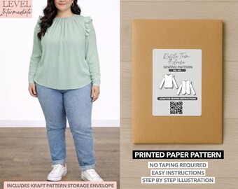 May include: A woman wearing a light green long-sleeve blouse with ruffle trim and blue jeans. Next to her is a brown paper pattern envelope with a white label that reads "Ruffle Trim Blouse Sewing Pattern". The text "Printed Paper Pattern" is also visible.