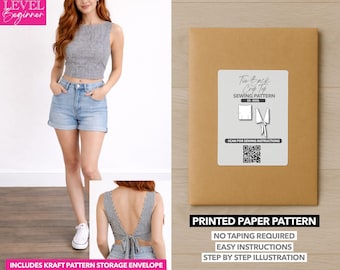 May include: A woman wearing a black and white gingham crop top and denim shorts. A brown paper pattern envelope with a label that reads "Tie Back Crop Top Sewing Pattern" is also shown. The pattern includes a kraft pattern storage envelope.