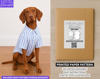 May include: A brown dog wearing a blue and white striped button-down shirt. Next to the dog is a brown paper pattern envelope with a label that reads "Button Down Short Sleeve Shirt Sewing Pattern". The text "Printed Paper Pattern" is also visible.