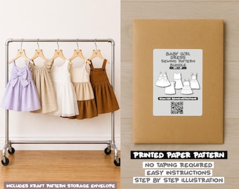 May include: A display of baby girl dresses on a rolling rack, including a lavender striped dress with a bow, and a brown corduroy jumper. A kraft paper envelope with a sewing pattern bundle label is also shown.