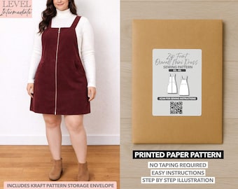 May include: A woman wearing a burgundy corduroy zip-front overall mini dress with a white turtleneck. The image also shows a brown paper pattern envelope with a label that reads "Zip Front Overall Mini Dress Sewing Pattern". The pattern includes easy instructions.