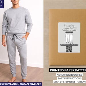 May include: A light gray jogger set, including a crew neck sweatshirt and drawstring pants. A brown paper pattern envelope with a white label that reads "Drawstring Jogger Pants Sewing Pattern". The text "Printed Paper Pattern" is also visible.