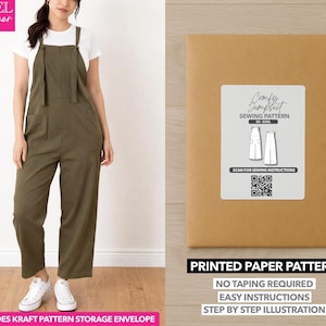 May include: An olive green jumpsuit with a white t-shirt. The jumpsuit has a bib-and-brace design with pockets. A kraft paper envelope with a sewing pattern label is on the right. The label reads "Comfy Jumpsuit Sewing Pattern".