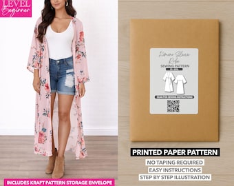 May include: A woman wearing a pink floral kimono with a white top and denim shorts. A brown paper envelope with a label that reads "Limono Sleeve Robe Sewing Pattern" is on the right. The text "Printed Paper Pattern" is below.