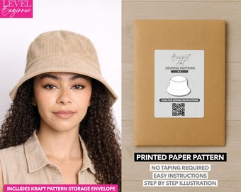 May include: A woman wearing a beige corduroy bucket hat. Next to her is a brown paper pattern envelope with a white label that reads "Bucket Hat Sewing Pattern." The text on the envelope says "Printed Paper Pattern" and "No Taping Required."