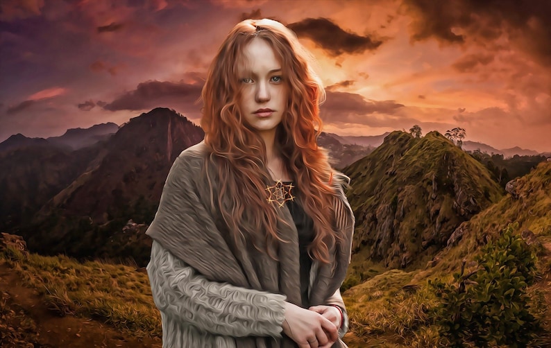 May include: A woman with long, curly red hair stands in front of a mountain range at sunset. She is wearing a gray knitted shawl and a necklace with a star-shaped pendant.