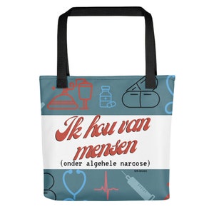 Op de afbeelding: Een blauwe tote bag met een wit paneel met de tekst "Ik hou van mensen (onder algehele narcose)" in rood. De tas is versierd met medische iconen, waaronder een stethoscoop, een hartslagmeter, een spuit en pillen.