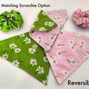 May include: Reversible dog bandana with a green and pink daisy print. The bandana comes with a matching scrunchie.