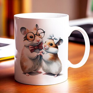 May include: White ceramic mug featuring a colourful illustration of two hamsters. The hamster on the left is wearing glasses and a bow tie. The hamster on the right is wearing a blue bow.