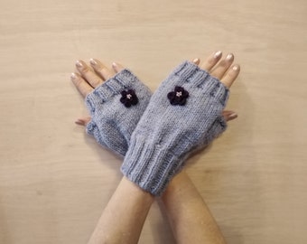 Hand knitted fingerless gloves with crochet flower
