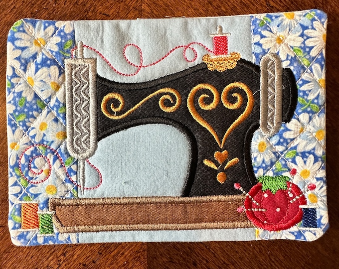 Mug Rug, Coaster, Sewing.  Approximately 5 x 7, Features a sewing machine, threads and pin cushion,  Quilted and embroidered