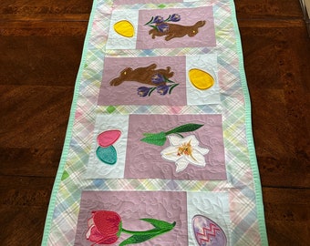 Easter Table Runner, Bunnies, Lilies, Tulips and Eggs.  Approximately 45 x 15 inches, ready to ship.  Quilted and Embroidered.
