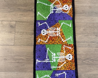 Halloween Skelton Table Runner.  Approximately 12 1/2 by 39 inches. Quilted and Embroidered