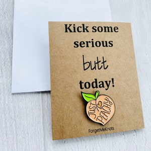 Kick some serious butt today! Peach pin badge