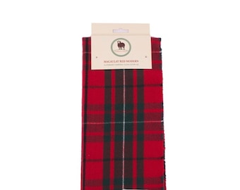 May include: A red and green plaid scarf with fringe. The scarf has a label that reads "Macaulay Red Modern Superfine Tartan Clan Scarf".