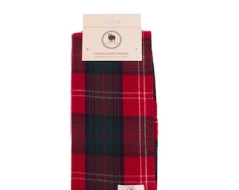 May include: Red and green plaid scarf with fringe. The scarf has a label that reads "Chisholm Red Modern Superfine Tartans Clan Scarves".