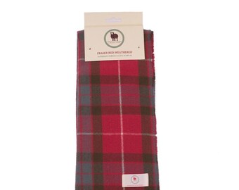 May include: A red, gray, and white plaid scarf with fringe. The scarf is packaged with a label that reads "Fraser Red Weathered Supersoft Tartan Clan Scarf".