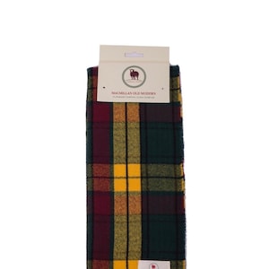 May include: A green, yellow and red tartan scarf with fringe. The scarf has a label that reads "Macmillan Old Modern" and "Superfine Lambswool Clan Scarf".
